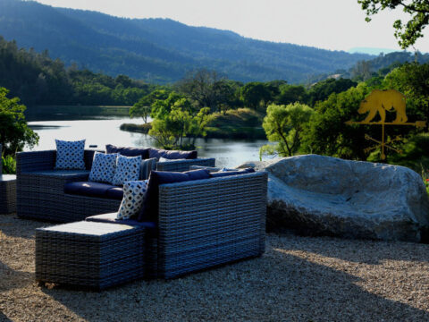 Outdoor patio seating overlooking scenic lake and hills