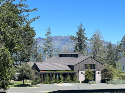 Modern barn-style building with mountain backdrop