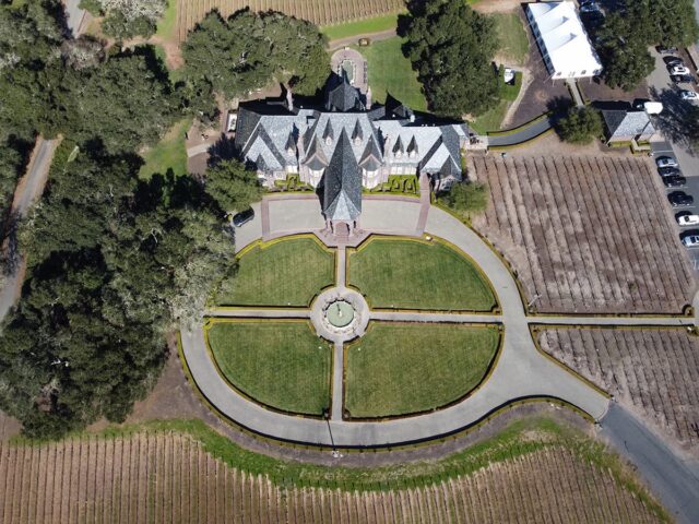 Aerial view of estate with circular driveway and vineyards