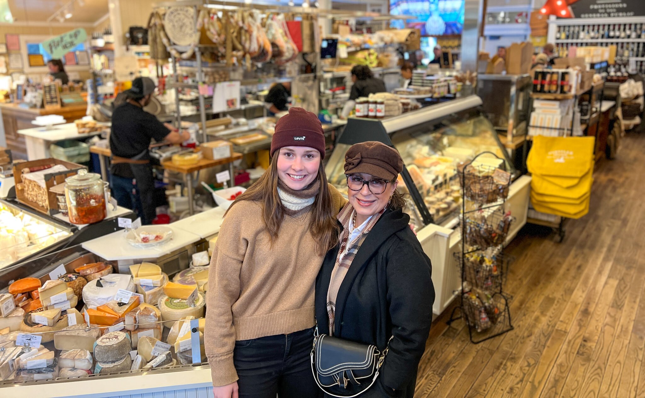 two women shopping for cheese and charcuterie