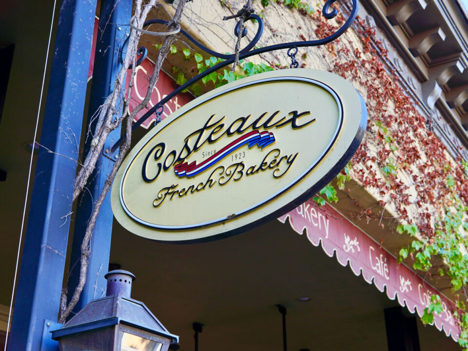 Costeaux French Bakery hanging storefront sign