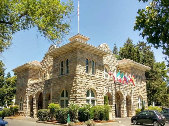 Historic stone Sonoma City Hall with flags