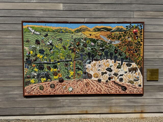 Outdoor mosaic mural of farm ecosystem cross-section