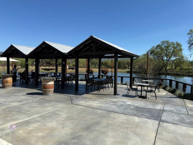 Lakeside patio with covered seating and tables