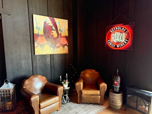 Cozy winery lounge with leather chairs and neon sign