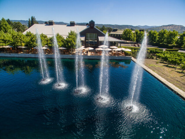 Winery patio overlooking pond with tall fountains