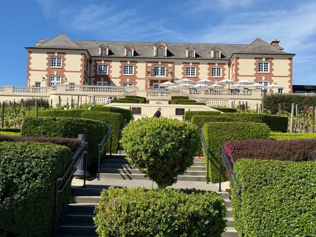Elegant vineyard estate with manicured hedges and mansion