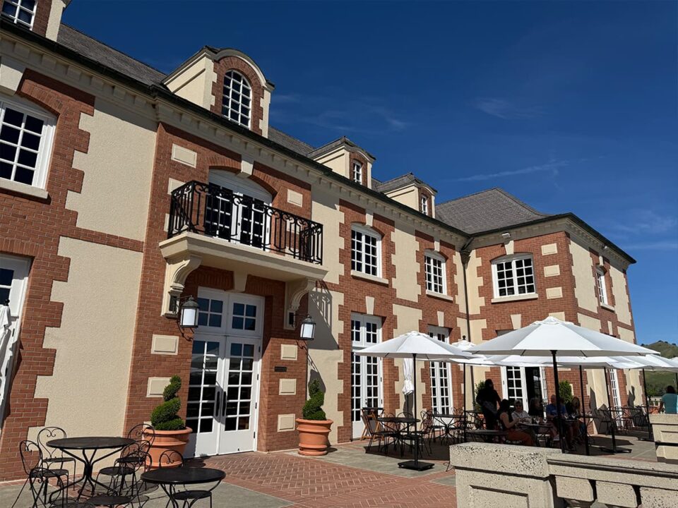 Elegant brick estate with outdoor patio seating